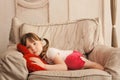 Sleepy little girl looking at camera in chair Royalty Free Stock Photo