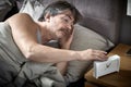 Sleepy man in bed wake up. Royalty Free Stock Photo