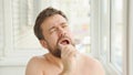 Sleepy man cleans teeth electric toothbrush Royalty Free Stock Photo