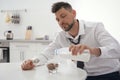 Sleepy man cooking breakfast at home Royalty Free Stock Photo