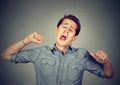 Sleepy man yawning stretching arms back Royalty Free Stock Photo