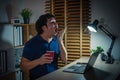 sleepy man yawning while working with laptop at night Royalty Free Stock Photo