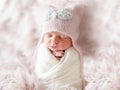 Newborn in beanie hat on a shaggy carpet Royalty Free Stock Photo