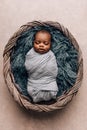 Sleepy swaddled African-American newborn baby boy