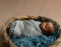 Sleepy swaddled African-American newborn baby boy