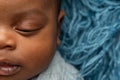 Sleepy swaddled African-American newborn baby boy