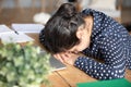 Sleepy tired Indian girl falling asleep at workplace close up