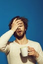 Sleepy tired man with headache hold cup of tea Royalty Free Stock Photo