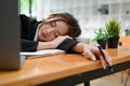 Sleepy and tired young Asian businesswoman taking nap or sleep on her desk Royalty Free Stock Photo