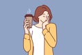 Sleepy woman holds paper cup of coffee and falls asleep standing up due to severe exhaustion