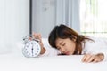 Sleepy woman trying turn off alarm clock Royalty Free Stock Photo