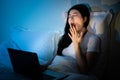 Sleepy yawn tired woman sitting on cosy bed Royalty Free Stock Photo