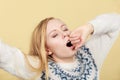 Sleepy yawning teenage woman in jumper