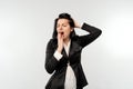 Sleepy young businesswoman, yawning with tired face, yawn from boredom, in black formal jacket white shirt, standing over white