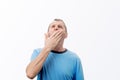 Sleepy young middle aged yawning covering his mouth with hand isolated on white background feeling. Tired  middle aged needs to Royalty Free Stock Photo