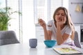 Sleepy young woman eating breakfast at home Royalty Free Stock Photo
