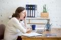 Sleepy young worker woman yawning Royalty Free Stock Photo