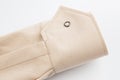 Sleeve detail, beige cotton fabric cuff, button closure