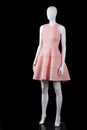 Sleeveless salmon dress with folds.