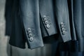 Sleeves of black men suits with four buttons Royalty Free Stock Photo