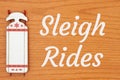 Sleigh Rides message with red and white winter sled Royalty Free Stock Photo