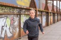 Slender Athletic Woman Jogging On A Bridge