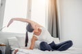 Slender sporty woman doing exercises on bed at home Royalty Free Stock Photo