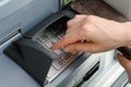 Female hand entering a secure PIN code at a cash point or ATM up close and in detail Royalty Free Stock Photo