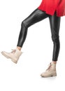 Slender female legs in black leggings and boots isolated on white background Royalty Free Stock Photo