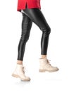 Slender female legs in black leggings and boots isolated on white background Royalty Free Stock Photo