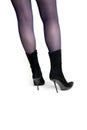Slender female legs in black suede boots back view Royalty Free Stock Photo