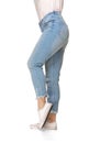 Slender female legs in blue jeans and sport shoes isolated on white background Royalty Free Stock Photo