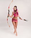 Slender girl in an Amazon costume with a bow and arrow in her hands Royalty Free Stock Photo