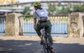 Woman with a handbag rides a bicycle along the city promenade preferring an active lifestyle Royalty Free Stock Photo