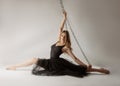 Slender girl dancing with a large chain in an incredible ballerina pose