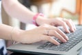 Slender hands of a beautiful woman worker He is using a computer Hands on the keyboard. Find the information on the internet at Royalty Free Stock Photo