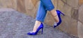 slender legs in blue breeches and heels Royalty Free Stock Photo
