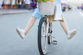 Girl is ridding around city on white bike