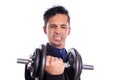 Slender man lifting weights on white background. Young latin man lifting weight with difficulty. Weak and funny man