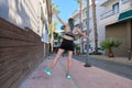 Slender sports girl teenager with back, female doing exercise, having fun