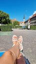 Slender tanned female legs in white shoes, selfie Royalty Free Stock Photo