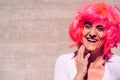 Slender and ugly woman with colorful wig posing ridiculously