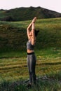 A slender woman does yoga exercises against an incredible backdrop of nature. The girl does yoga in the fresh air.