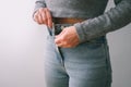 A slender woman fastens a button of her blue jeans. Weight ungain woman getting dressed wearing jeans. Close up of girl buttoning Royalty Free Stock Photo
