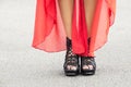 Slender woman legs on heels and red dress Royalty Free Stock Photo