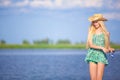 Young blonde girl fishing in lake Royalty Free Stock Photo