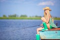 Young blonde girl fishing in lake Royalty Free Stock Photo
