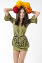 Slender young brunette woman in a dress with a bouquet of autumn flowers on her head Royalty Free Stock Photo