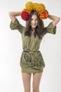 Slender young brunette woman in a dress with a bouquet of autumn flowers on her head Royalty Free Stock Photo