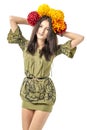 Slender young cheerful girl brown hair dances with a bouquet of colorful flowers on her head Royalty Free Stock Photo